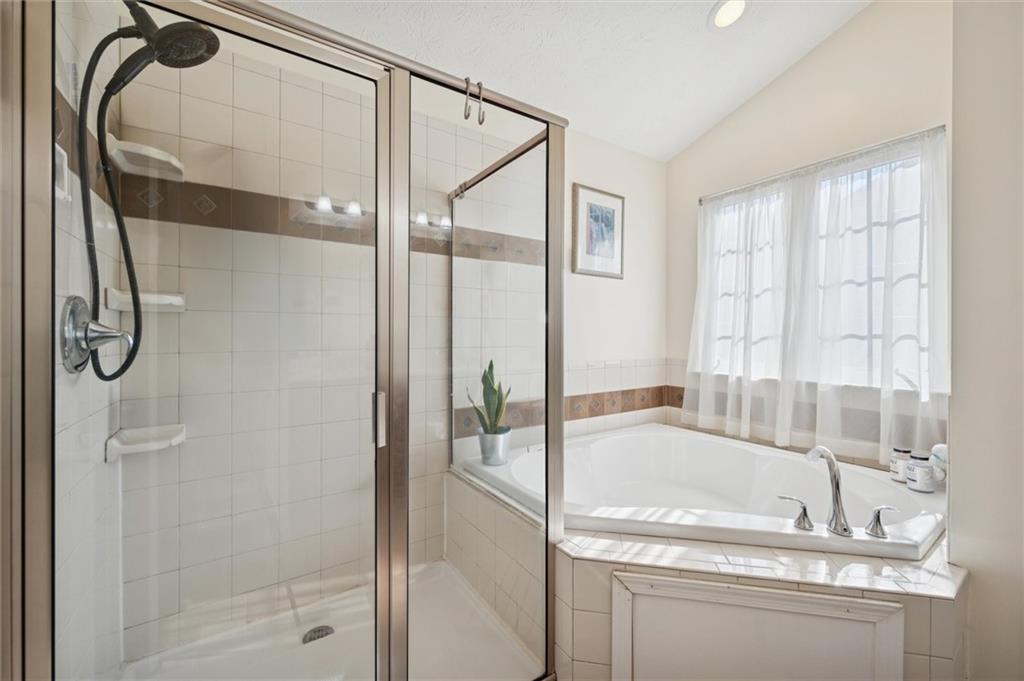 1005 Autumn Woods Drive Coraopolis, PA 15108 - Photo 27 of 50 a bathroom with a granite countertop vanity mirror and a bathtub