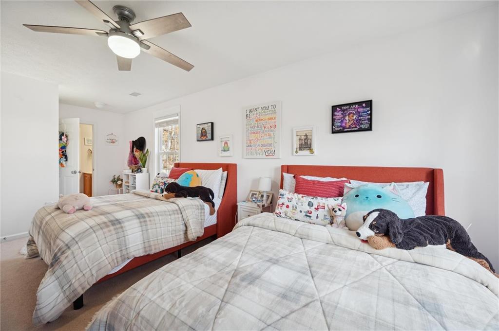 1005 Autumn Woods Drive Coraopolis, PA 15108 - Photo 32 of 50 a bedroom with two bed and a chandelier