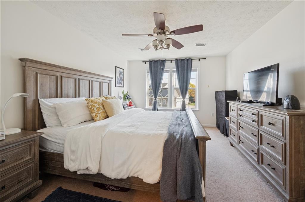 1005 Autumn Woods Drive Coraopolis, PA 15108 - Photo 37 of 50 a spacious bedroom with a large bed and a chandelier