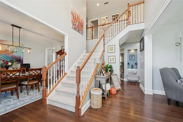 a dining room with furniture a rug and wooden floor