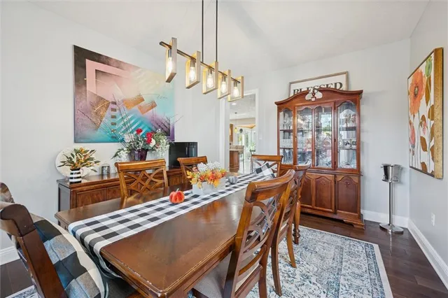 a view of a dining room with furniture and a chandelier