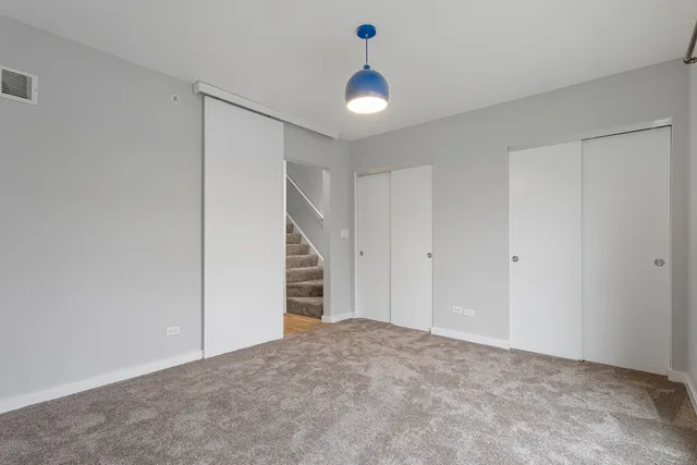 a view of an empty room with a ceiling fan