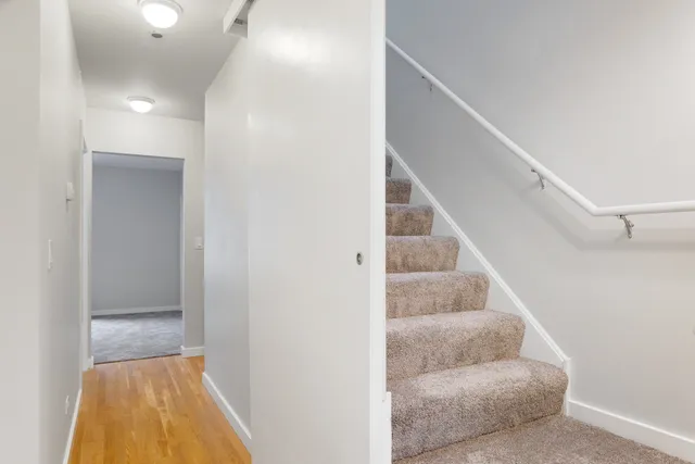a view of entryway and hall with wooden floor