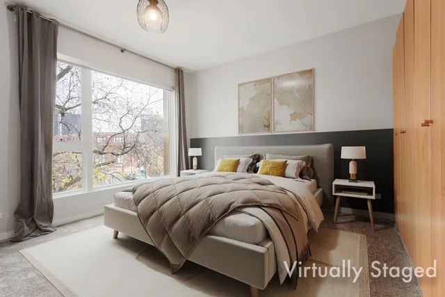 a bedroom with a bed and a large window