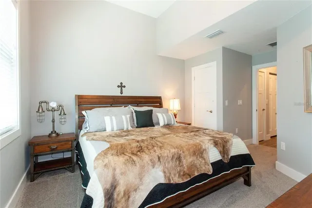 a bedroom with a bed and window