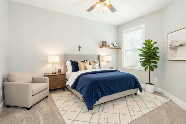 a bedroom with a bed and a potted plant