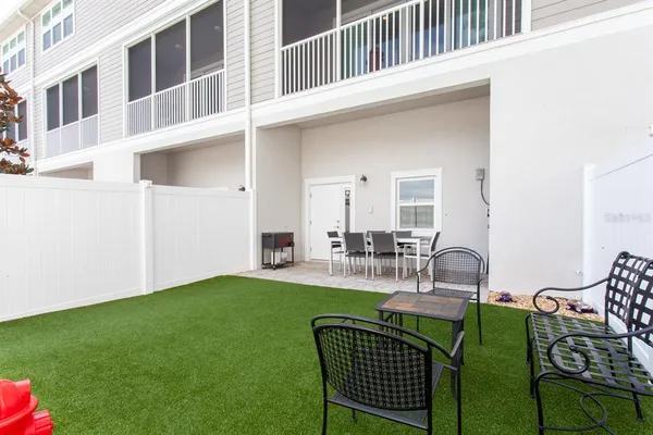 a view of an house with backyard and patio