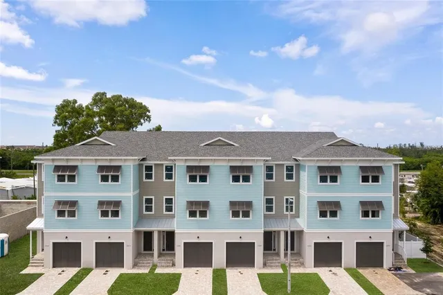 a front view of a building with a garden