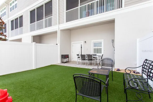a view of an house with backyard and patio