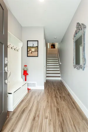 a view of a hallway with wooden floor and entryway
