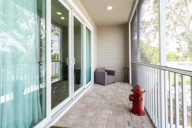 a porch with a table and chairs
