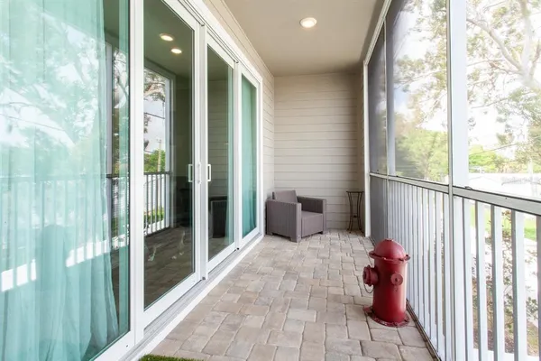 a porch with a table and chairs