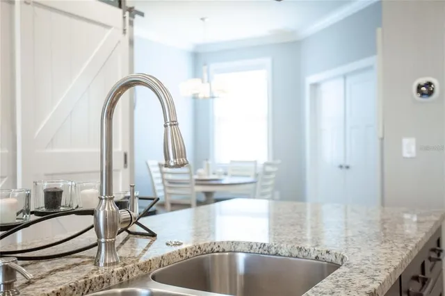 a kitchen with granite countertop a sink and a window