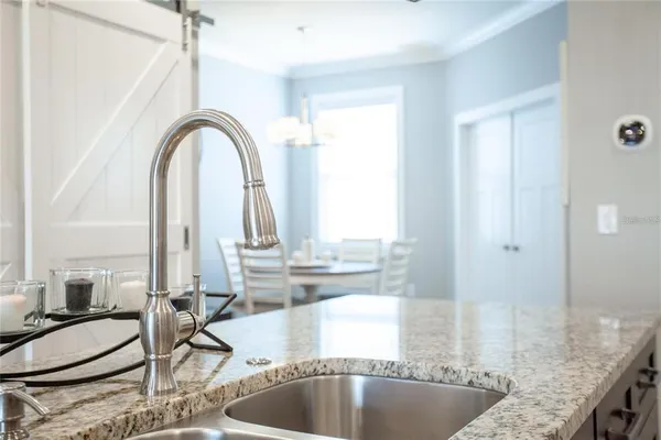 a kitchen with granite countertop a sink and a window