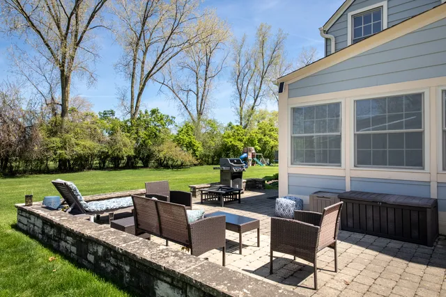 a view of a patio with couches chairs and a yard