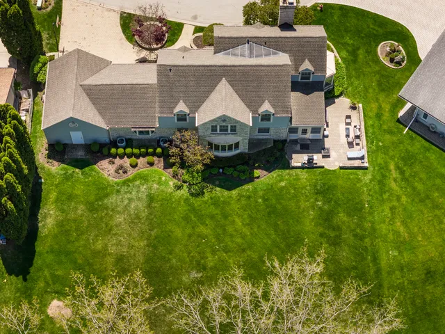 an aerial view of a house with swimming pool patio and outdoor seating