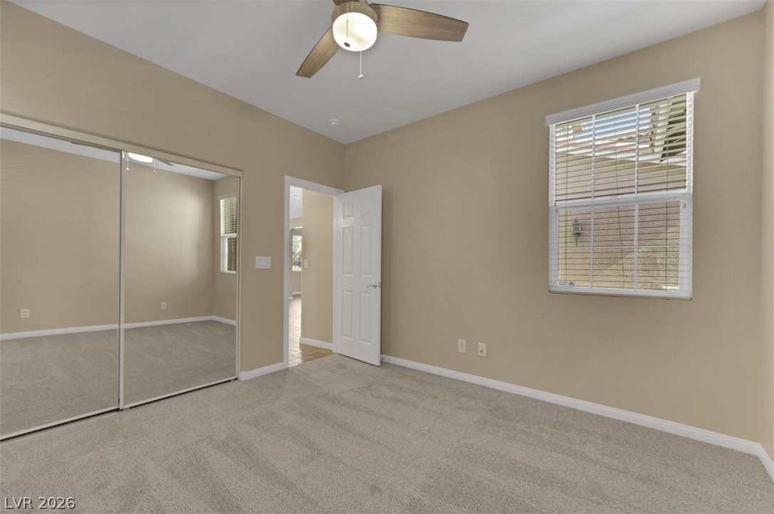 10328 Hawk Ravine Street Las Vegas, NV 89178 - Photo 22 of 55 A well-lit bedroom features plush carpeting and convenient mirrored closet doors.