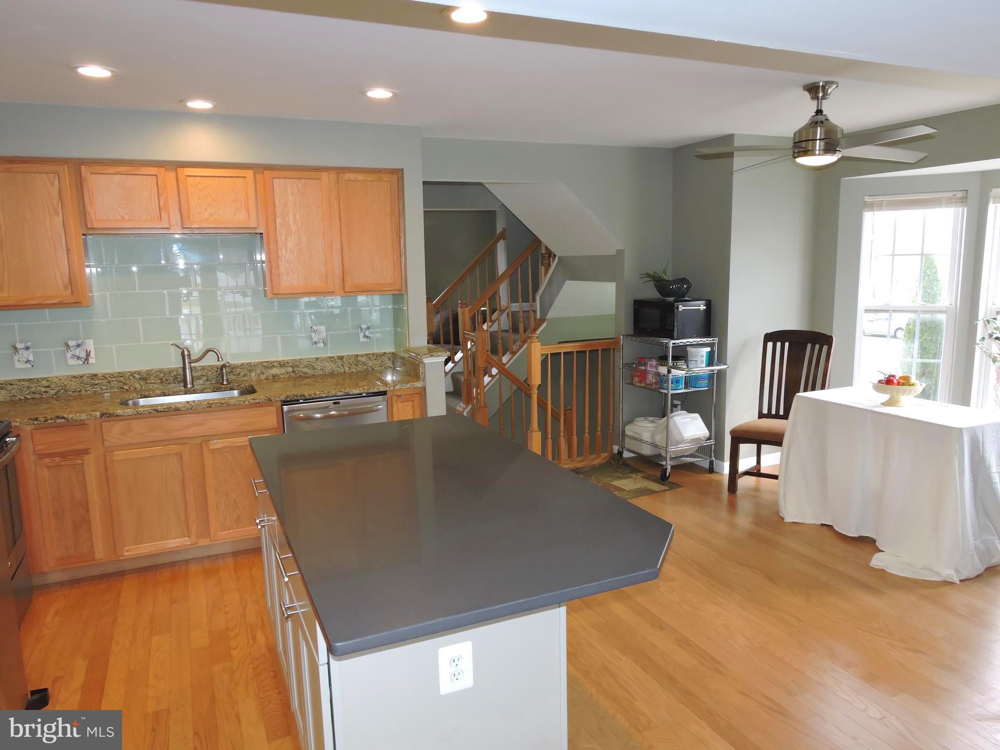 1227 Steed Street Ranson, WV 25438 - Photo 11 of 37 a view of a kitchen with kitchen island a large window cabinets a sink and stainless steel appliances