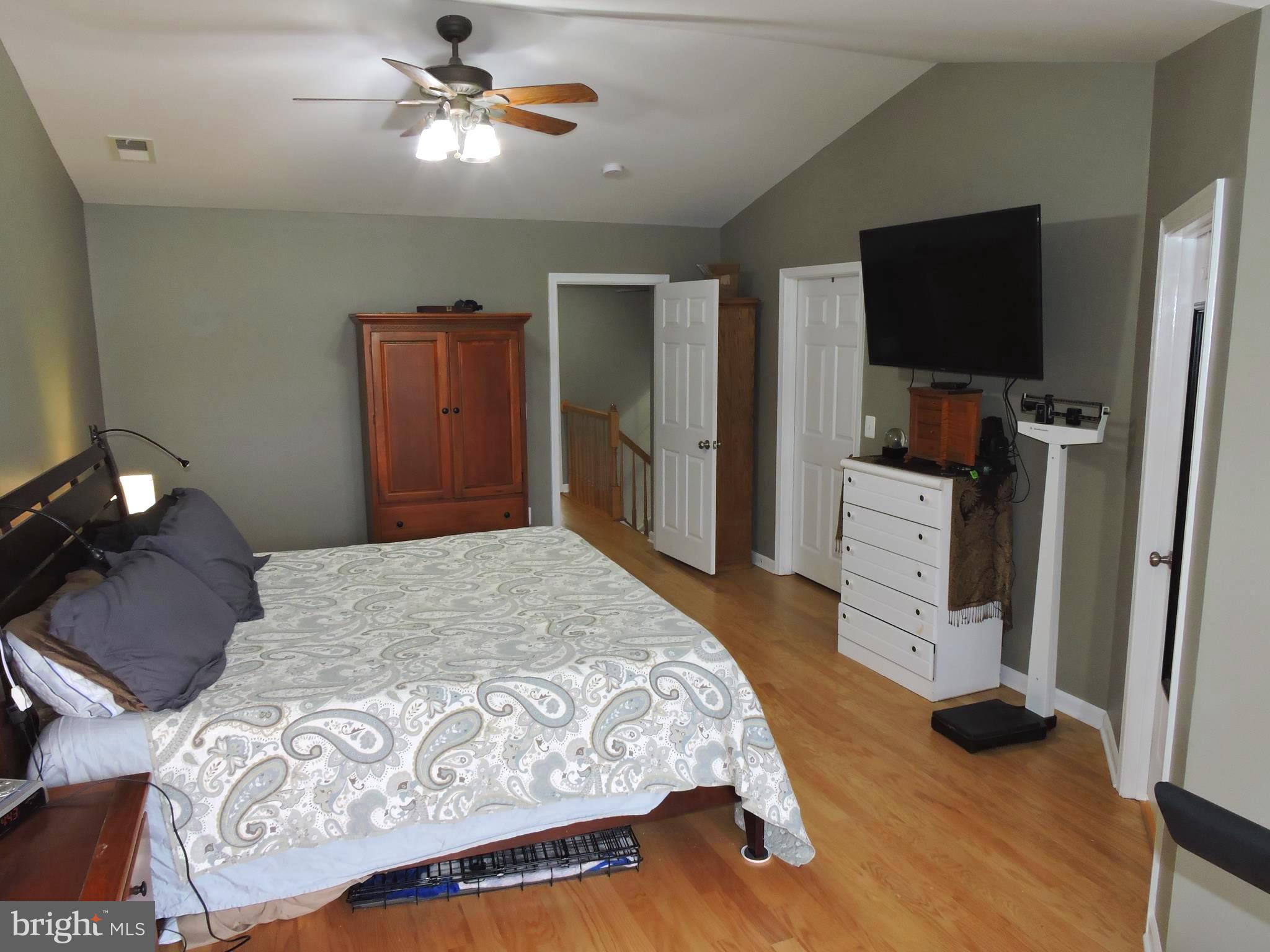 1227 Steed Street Ranson, WV 25438 - Photo 21 of 37 a bedroom with a bed and a flat tv screen on dresser