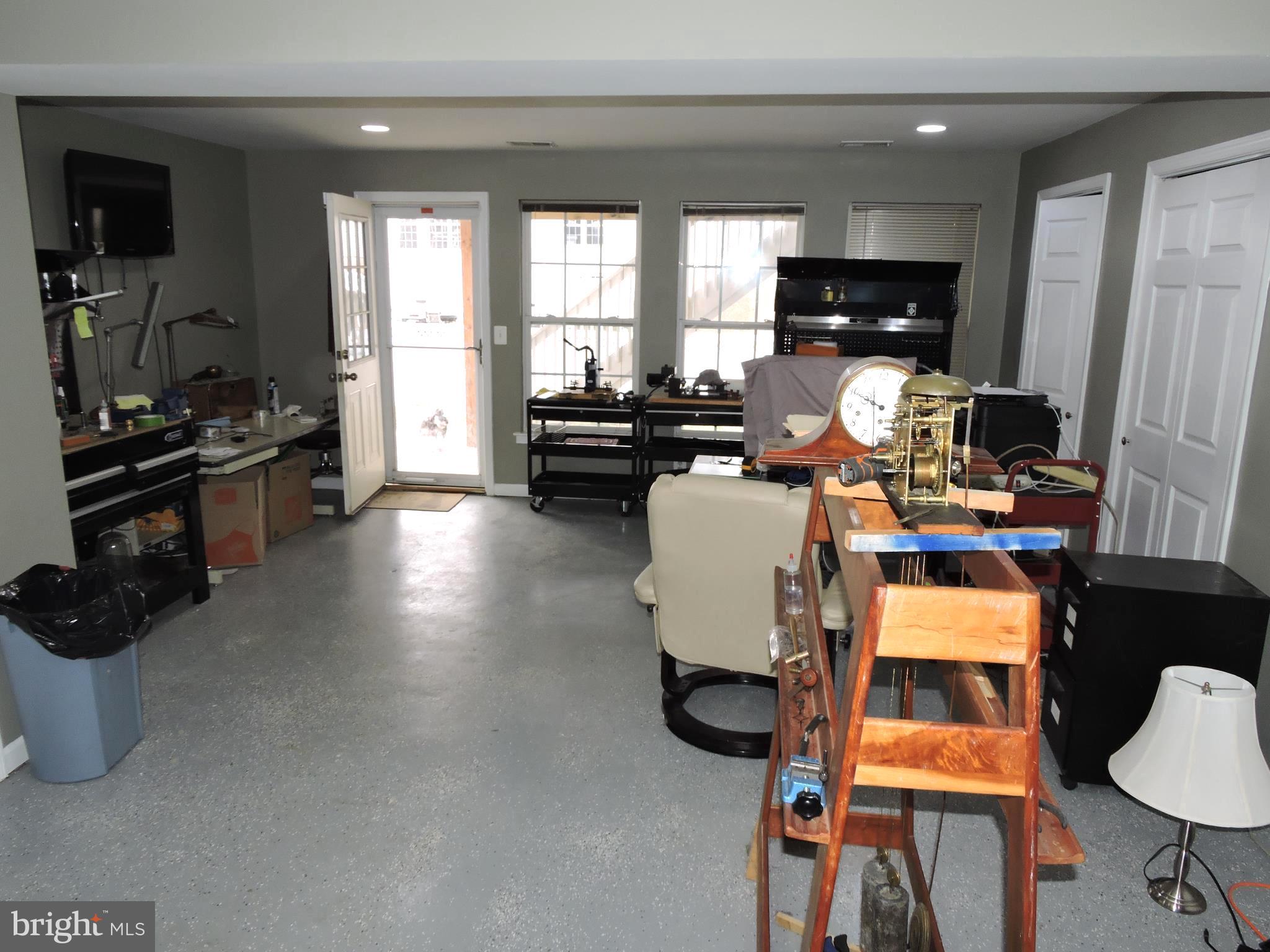 1227 Steed Street Ranson, WV 25438 - Photo 27 of 37 a living room with furniture a fireplace and a flat screen tv