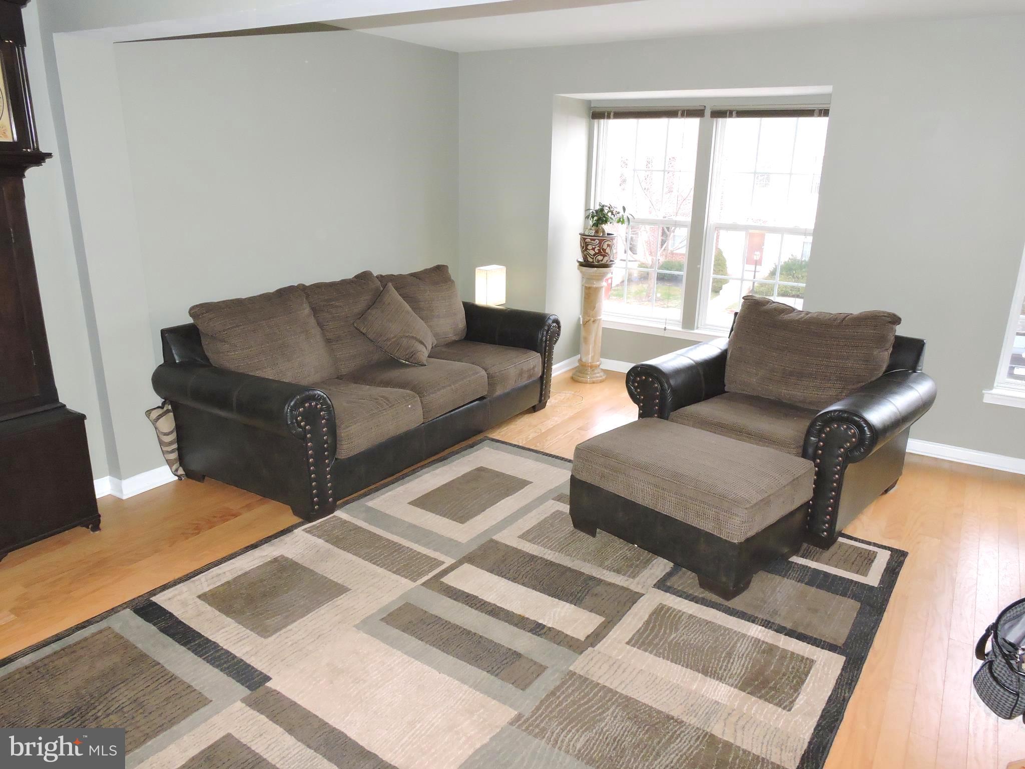 1227 Steed Street Ranson, WV 25438 - Photo 5 of 37 a living room with couches rug and a large window