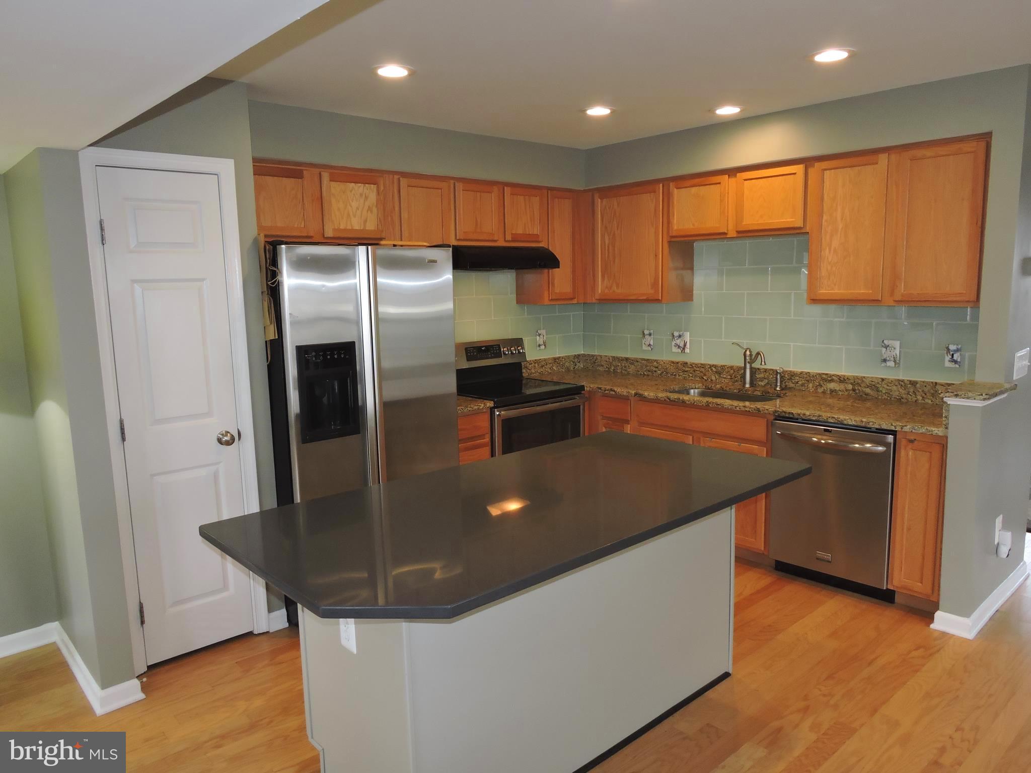 1227 Steed Street Ranson, WV 25438 - Photo 9 of 37 a kitchen with stainless steel appliances granite countertop a sink a refrigerator and a stove