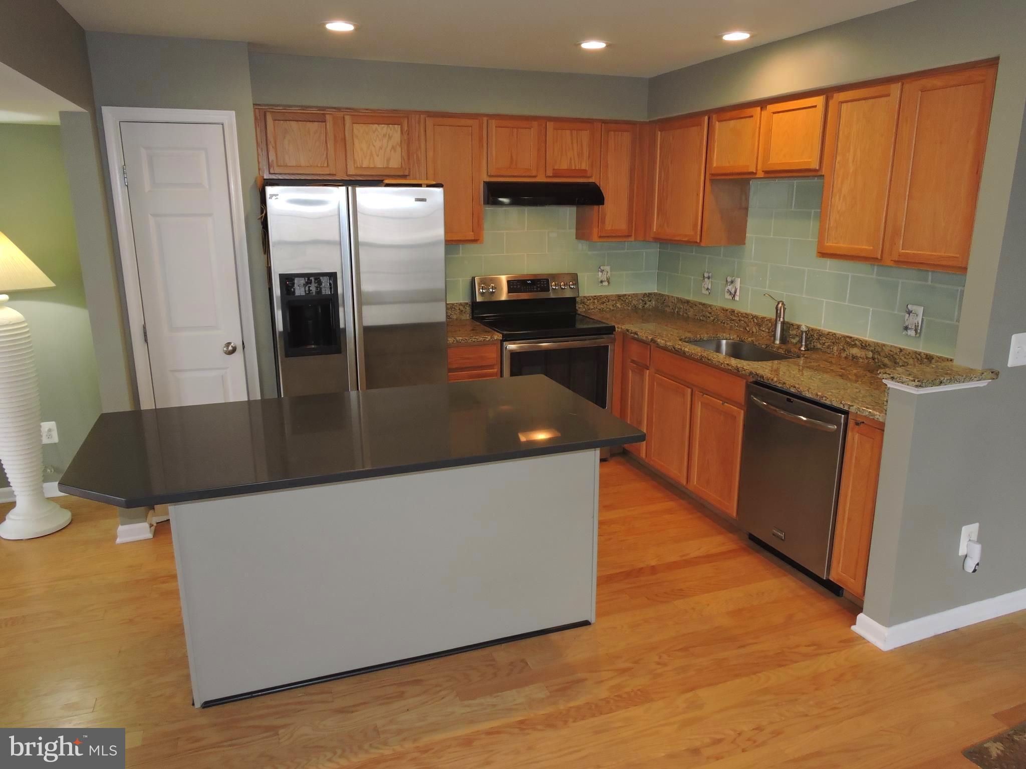 1227 Steed Street Ranson, WV 25438 - Photo 10 of 37 a kitchen with stainless steel appliances granite countertop a refrigerator a sink a stove and a wooden floors