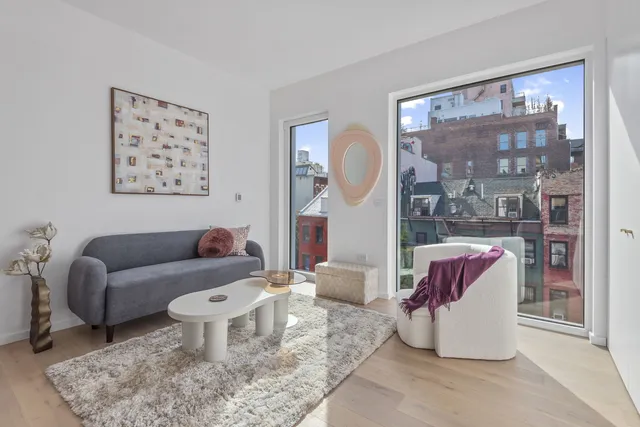a living room with furniture and a painting