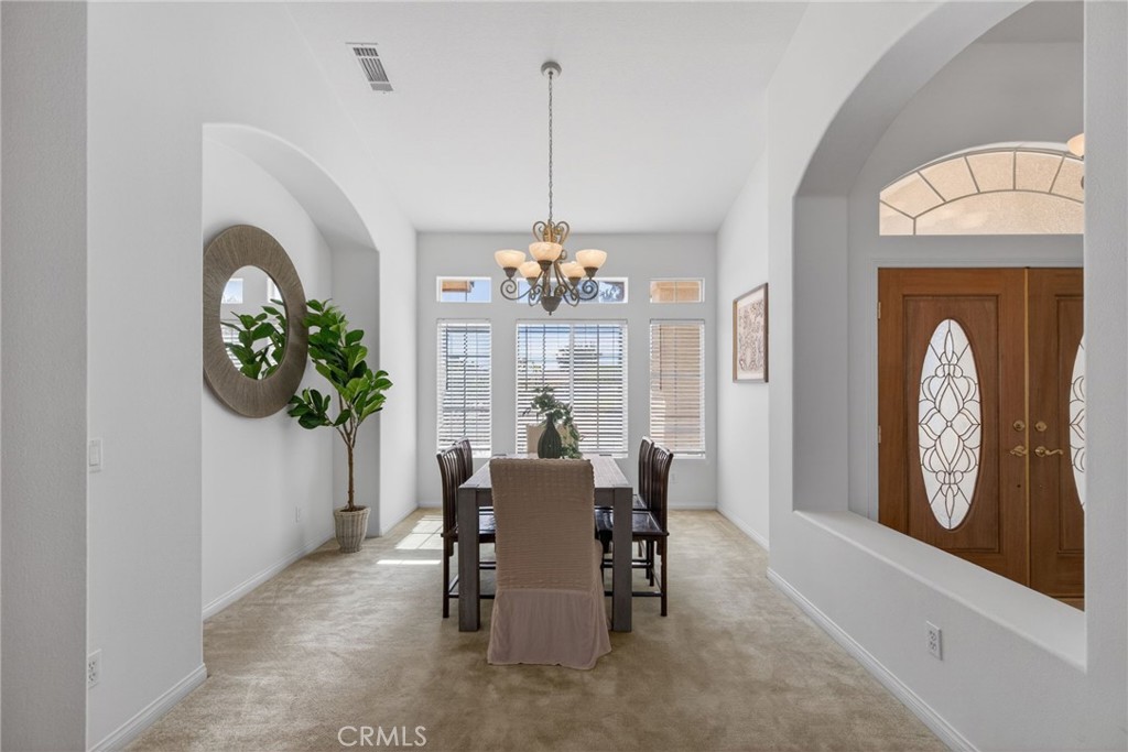 6201 Omega Street Riverside, CA 92506 - Photo 11 of 70 a dining room with furniture a livingroom and chandelier
