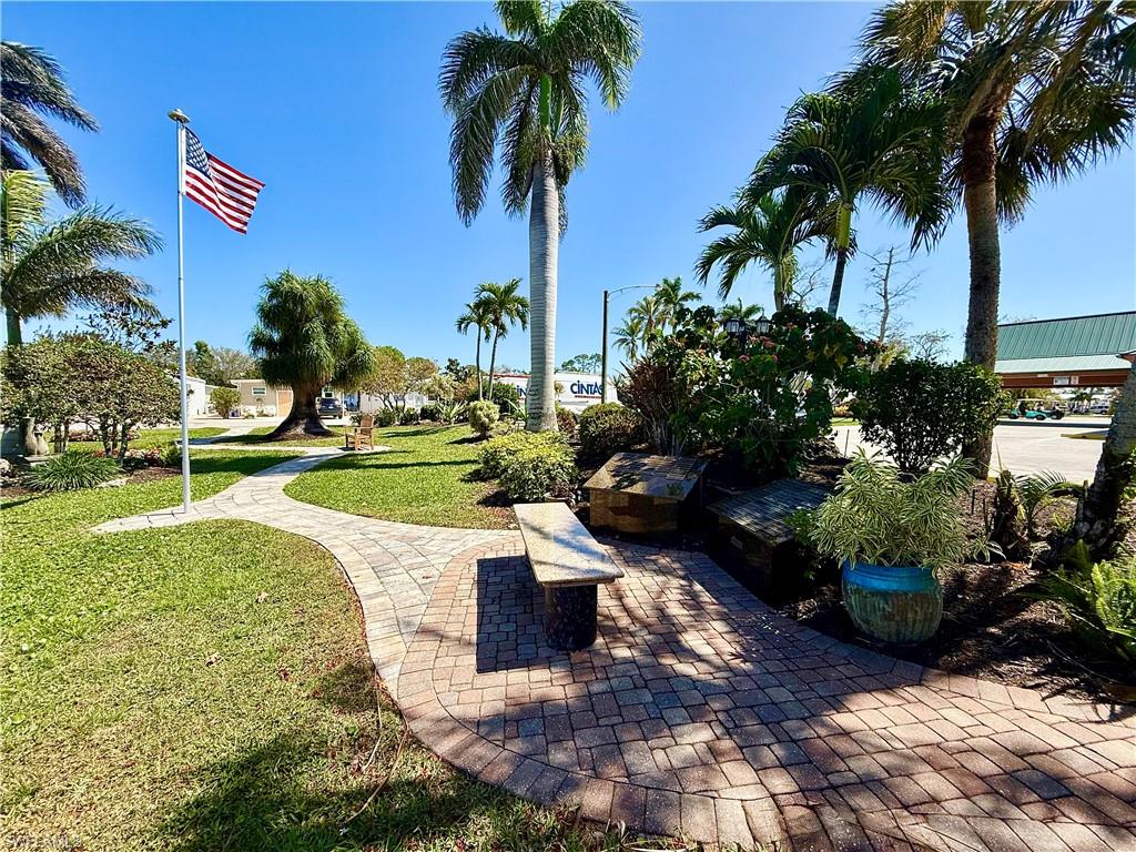 351 Bobcat Run Naples, FL 34114 - Photo 27 of 38 a view of a swimming pool with a garden