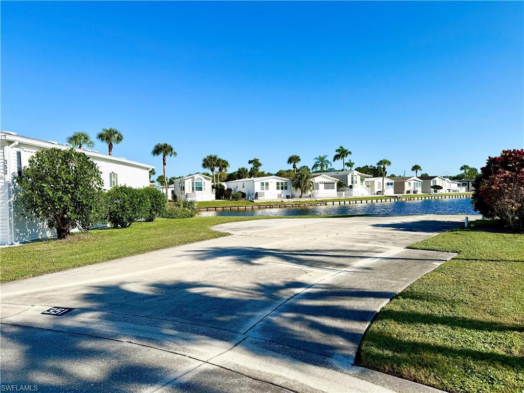 351 Bobcat Run Naples, FL 34114 - Photo 9 of 38 a view of swimming pool and trees in the background