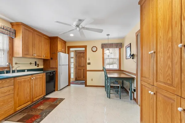a large kitchen with a window and stainless steel appliances