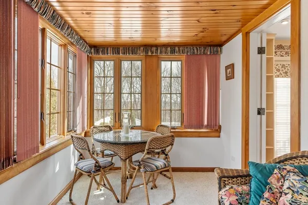 a dining room with furniture and window
