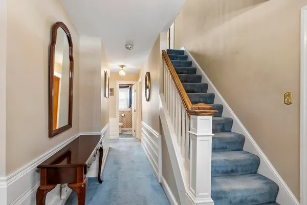 a view of entryway and hall with wooden floor