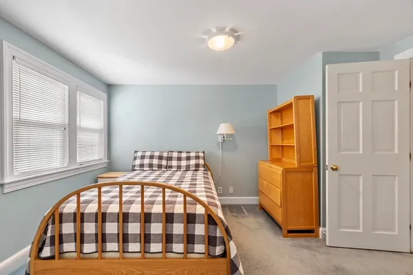 a bedroom with a bed and a lamp