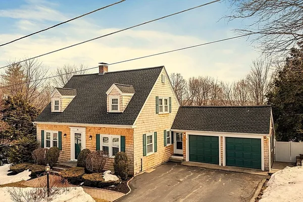 a view of a house with a tree in the yard