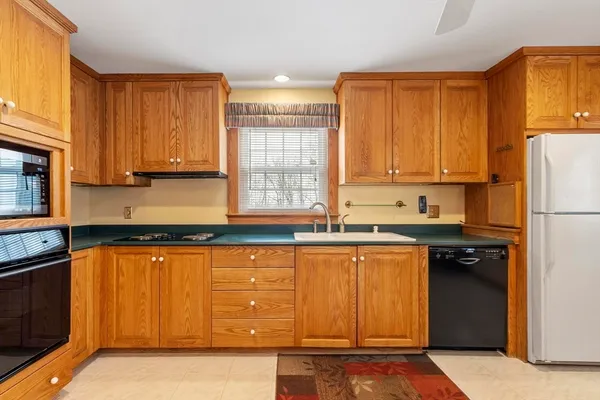 a kitchen with stainless steel appliances granite countertop a stove a sink dishwasher and a refrigerator