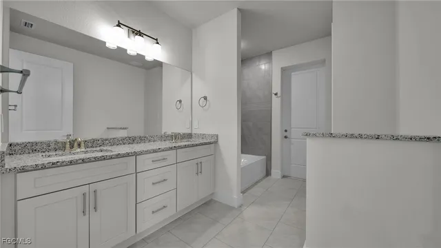 a bathroom with a granite countertop sink two mirror and a
