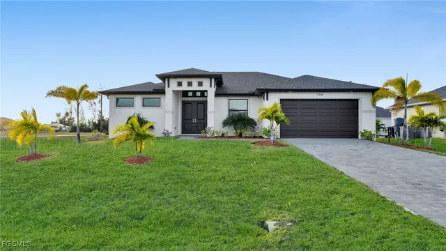 a front view of a house with a yard and entertaining space