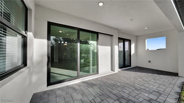 a view of an empty room with glass door