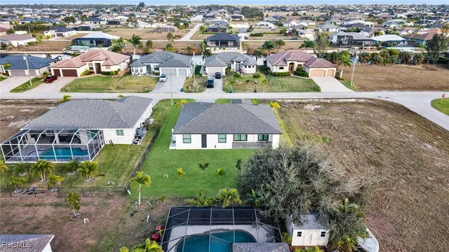 an aerial view of residential houses with yard