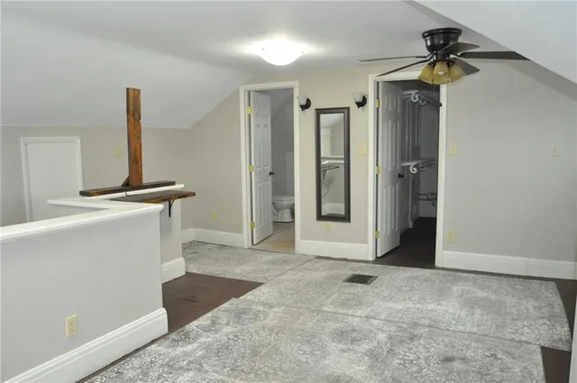 a view of empty room with ceiling fan