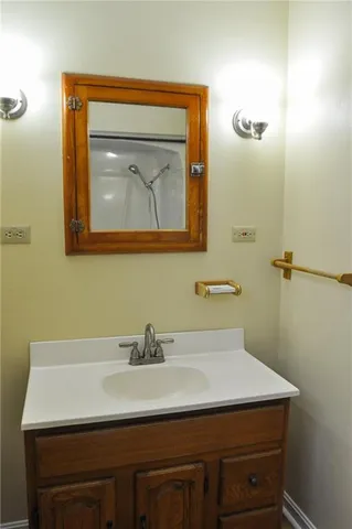a bathroom with a sink a mirror and vanity