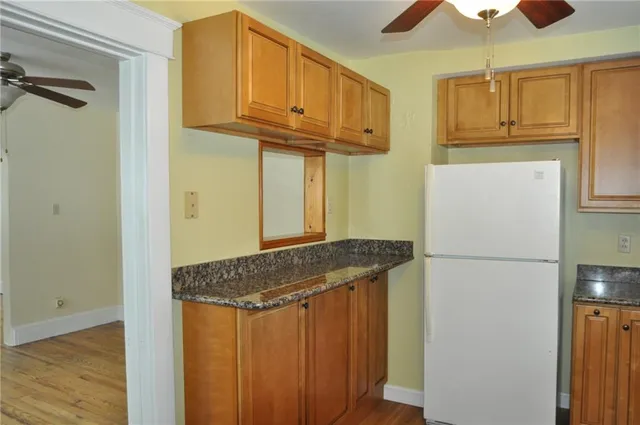 a kitchen with a refrigerator and a stove