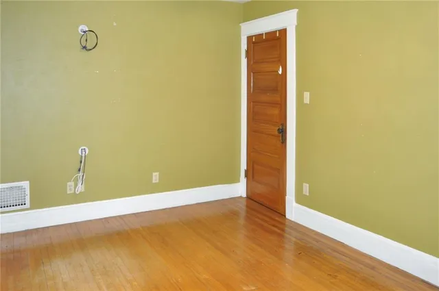 a view of a room with wooden floor