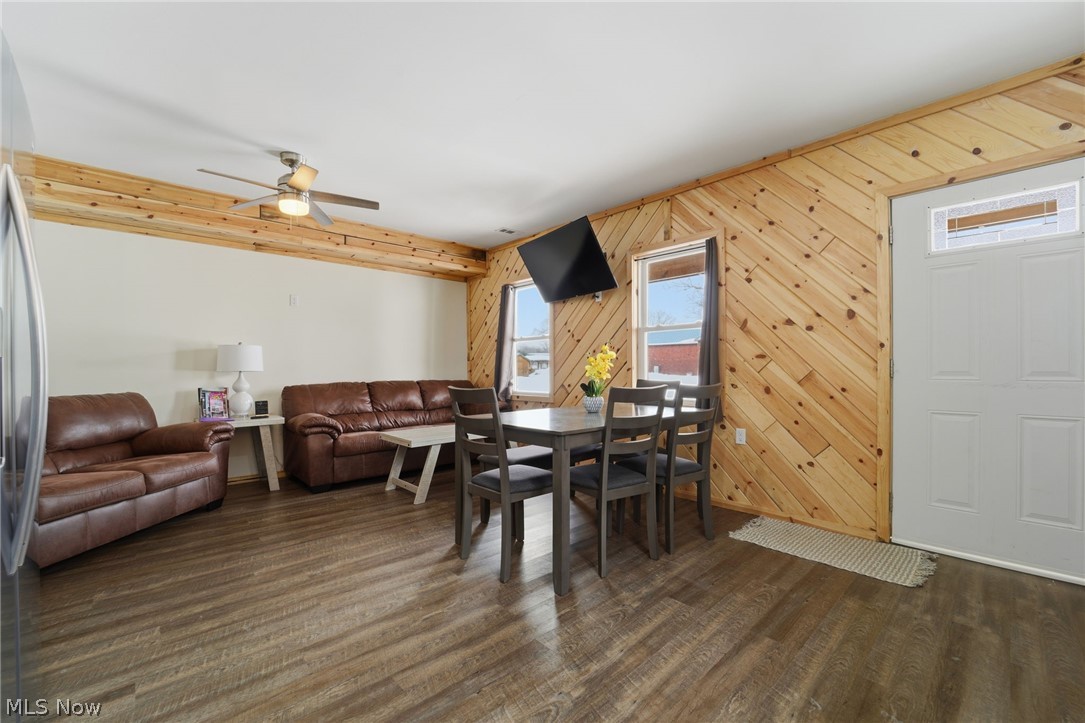 5919 Lake Road West, Unit 32 Ashtabula, OH 44004 - Photo 7 of 23 Dining space featuring wood walls, dark wood finished floors, and a ceiling fan
