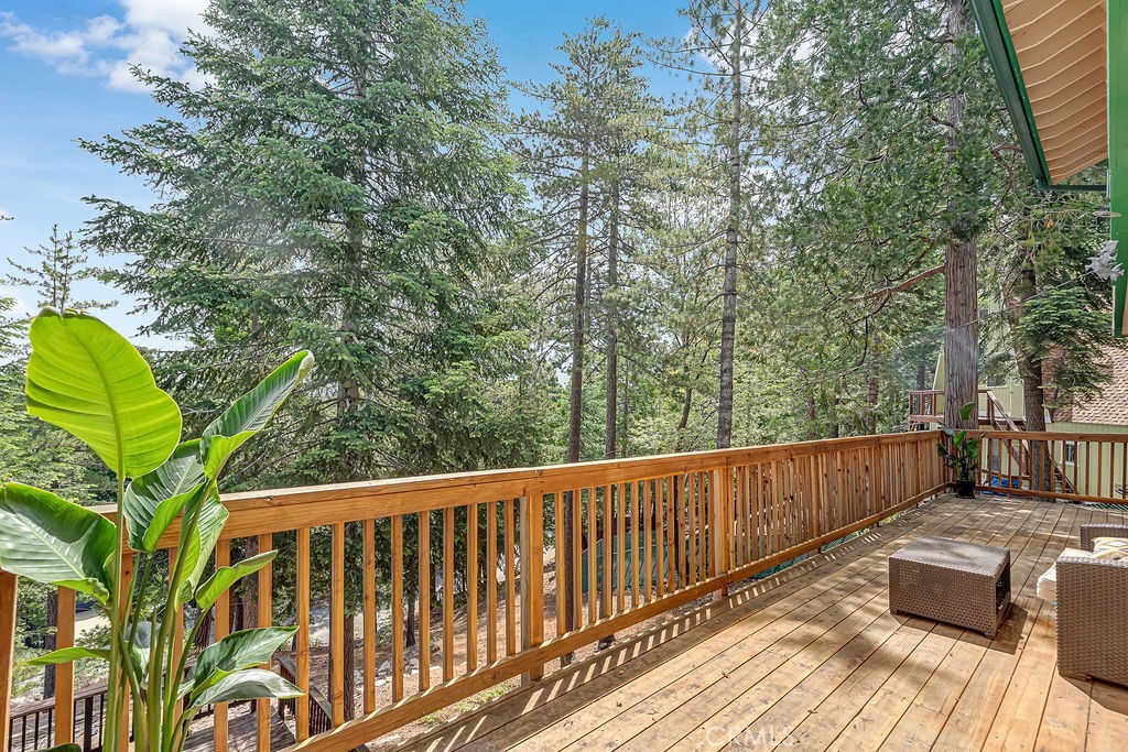 318 Old Toll Road Lake Arrowhead, CA 92352 - Photo 21 of 44 a view of balcony with wooden floor and outdoor seating
