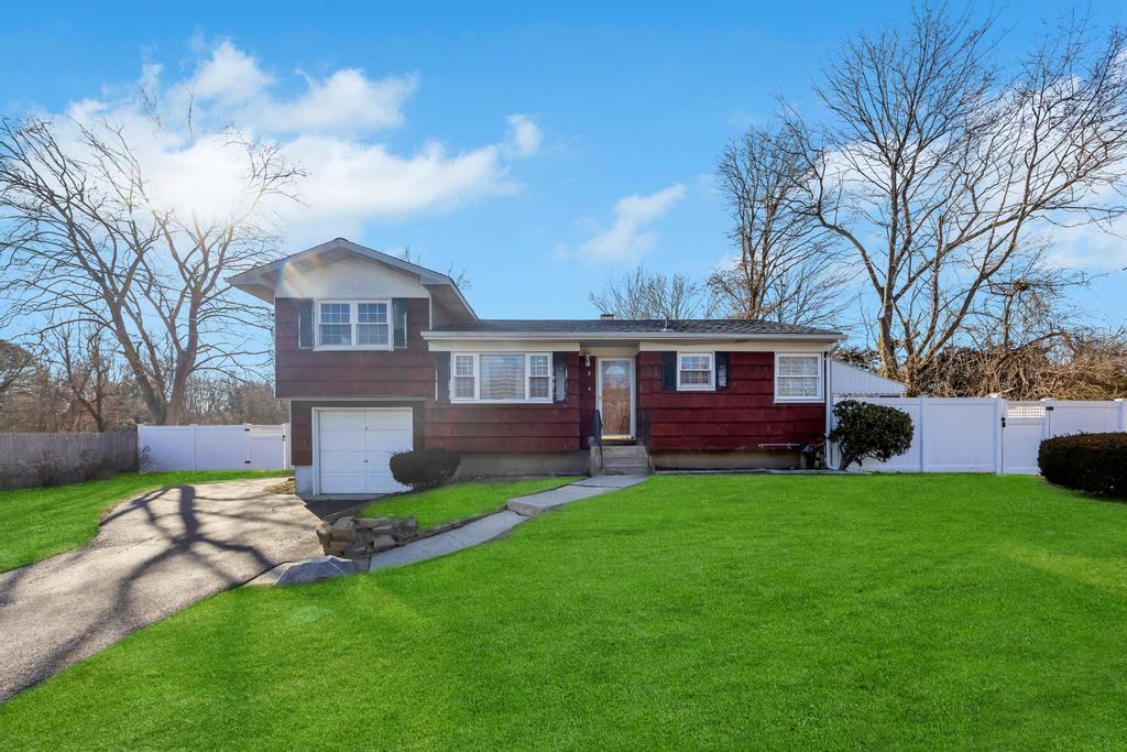 8 Wagner Drive Coram, NY 11727 - Photo 1 of 1 a view of a yard in front of a house with large tree