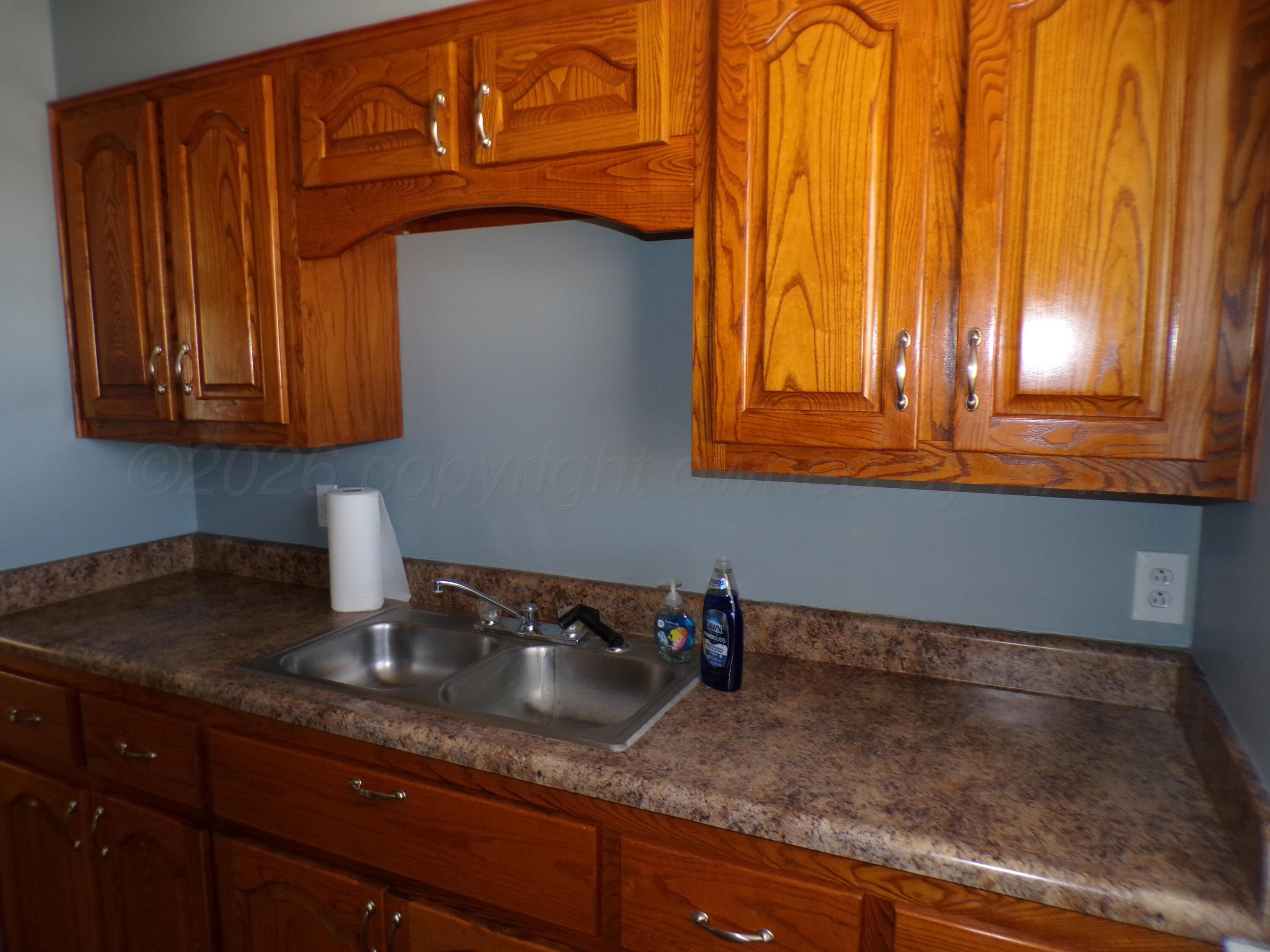 403 North Robey Avenue Fritch, TX 79036 - Photo 14 of 24 a kitchen with a sink cabinets and a window
