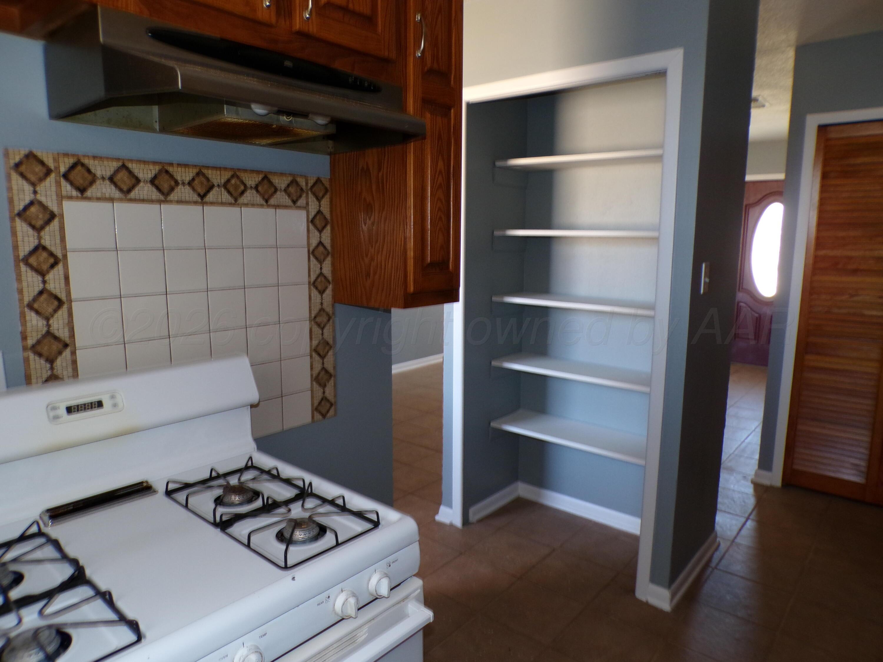 403 North Robey Avenue Fritch, TX 79036 - Photo 15 of 24 a kitchen with a refrigerator and a stove